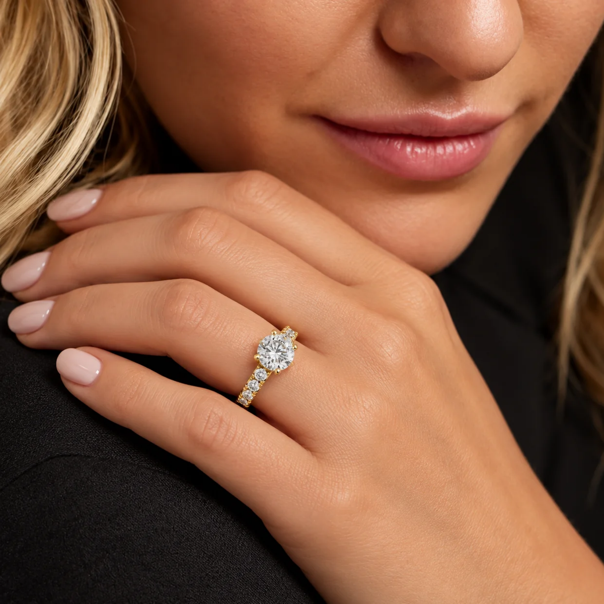 Woman wearing a round diamond engagement ring in 14K yellow gold with diamond-accented band - ZQ Brands